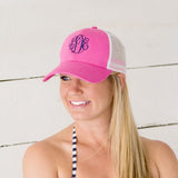 Pink with white mesh trucker hat. Monogram on front center. 
